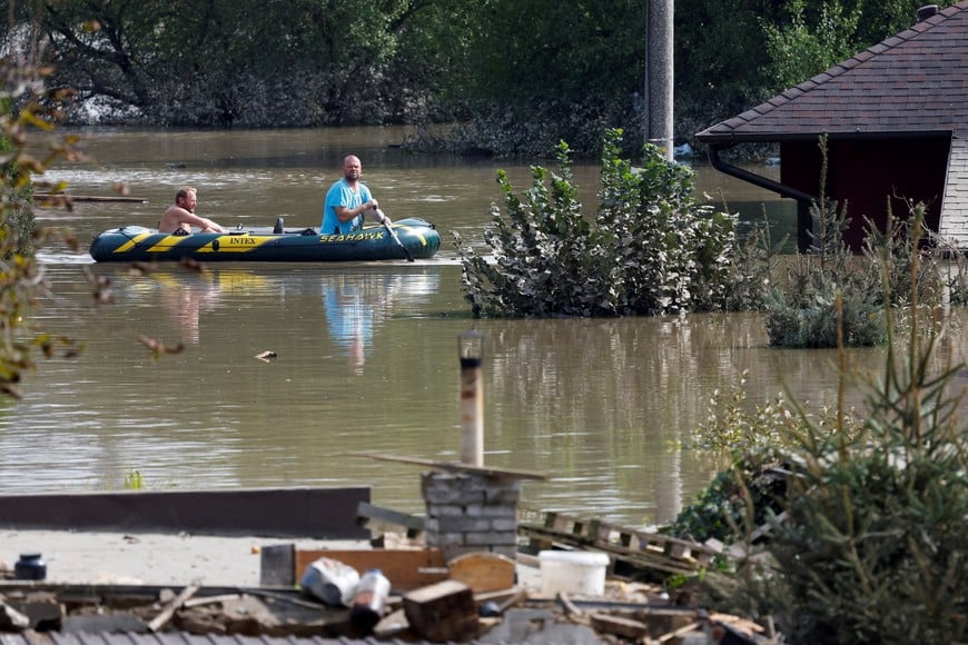 FILE PHOTO: A man uses a dinghy in a flood-affected area following heavy rainfalls in Ostrava, Czech Republic, September 17, 2024. REUTERS/David W Cerny/File Photo