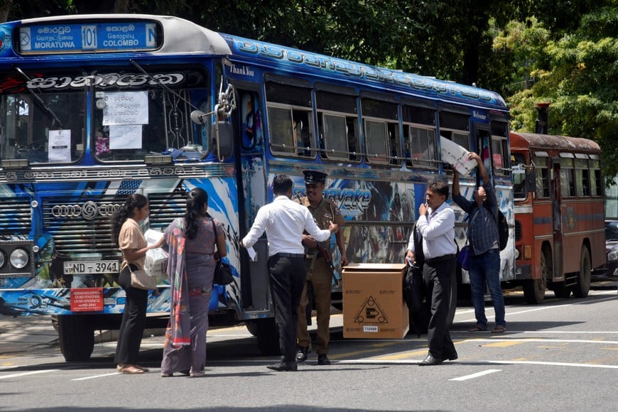 Polling officials prepare to board a bus after receiving the election materials from a distribution centre, a day before the presidential election, in Colombo, Sri Lanka, September 20, 2024. REUTERS/Stringer