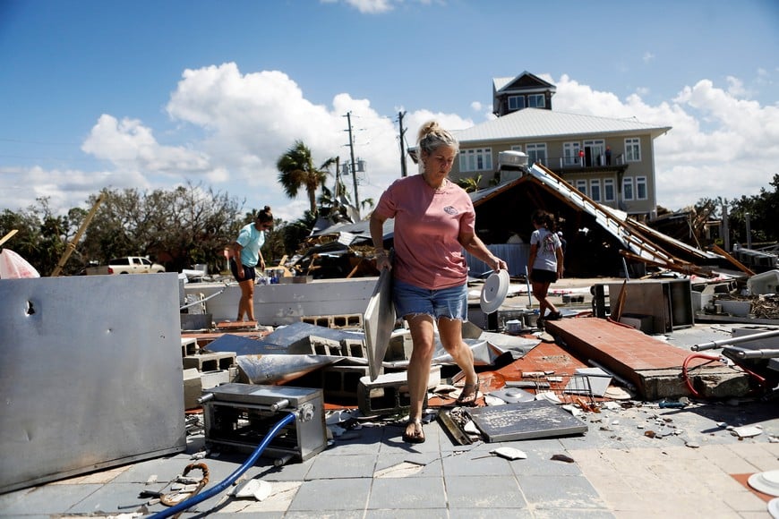 Nikki Wicker, co-owner of Roy's Restaurant, cleans after Hurricane Helene made landfall overnight, in Steinhatchee, Florida, U.S., September 27, 2024. REUTERS/Octavio Jones