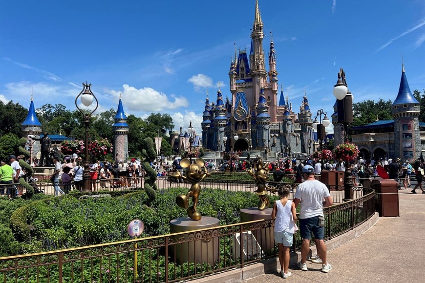 FILE PHOTO: People gather ahead of the "Festival of Fantasy" parade at the Walt Disney World Magic Kingdom theme park in Orlando, Florida, U.S. July 30, 2022.  REUTERS/Octavio Jones/File Photo