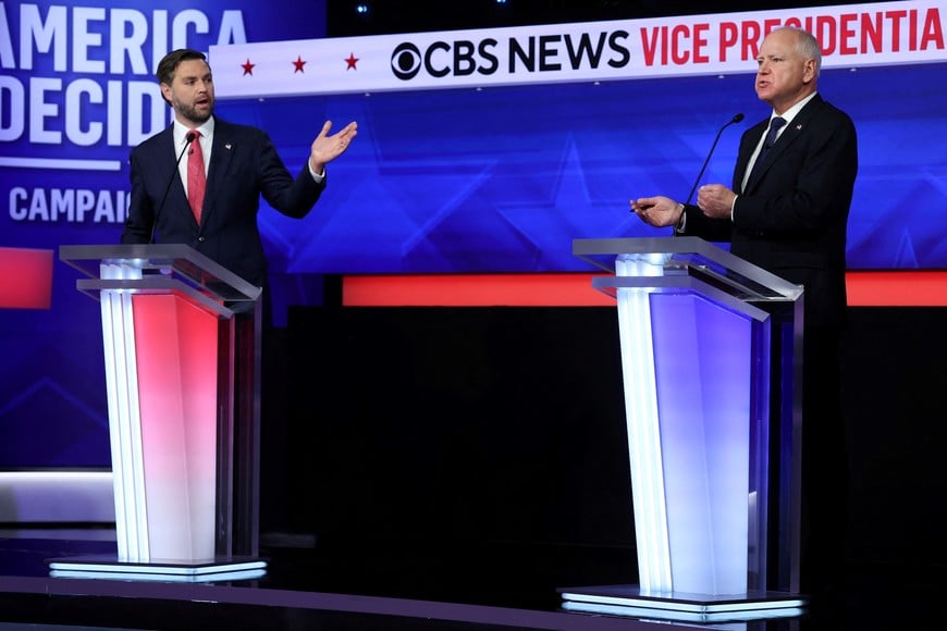 Republican vice presidential nominee U.S. Senator JD Vance (R-OH) and Democratic vice presidential nominee Minnesota Governor Tim Walz gesture as they speak during a debate hosted by CBS in New York, U.S., October 1, 2024. REUTERS/Mike Segar