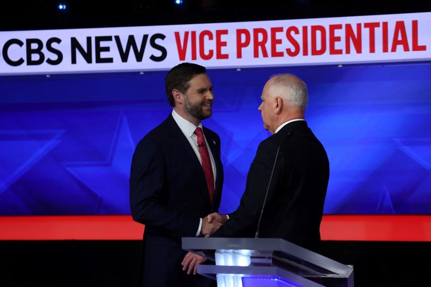 Democratic vice presidential nominee Minnesota Governor Tim Walz and Republican vice presidential nominee U.S. Senator JD Vance shake hands at the end of the Vice Presidential debate hosted by CBS in New York, U.S., October 1, 2024. REUTERS/Mike Segar