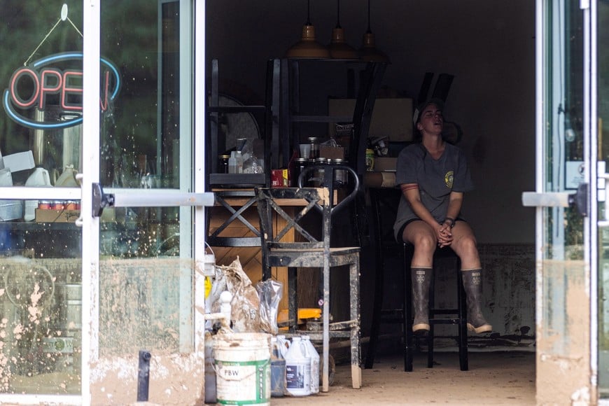 A woman reacts inside a store affected by floods following the passing of Hurricane Helene, in Old Fort, North Carolina, U.S., October 4, 2024.  REUTERS/Eduardo Munoz