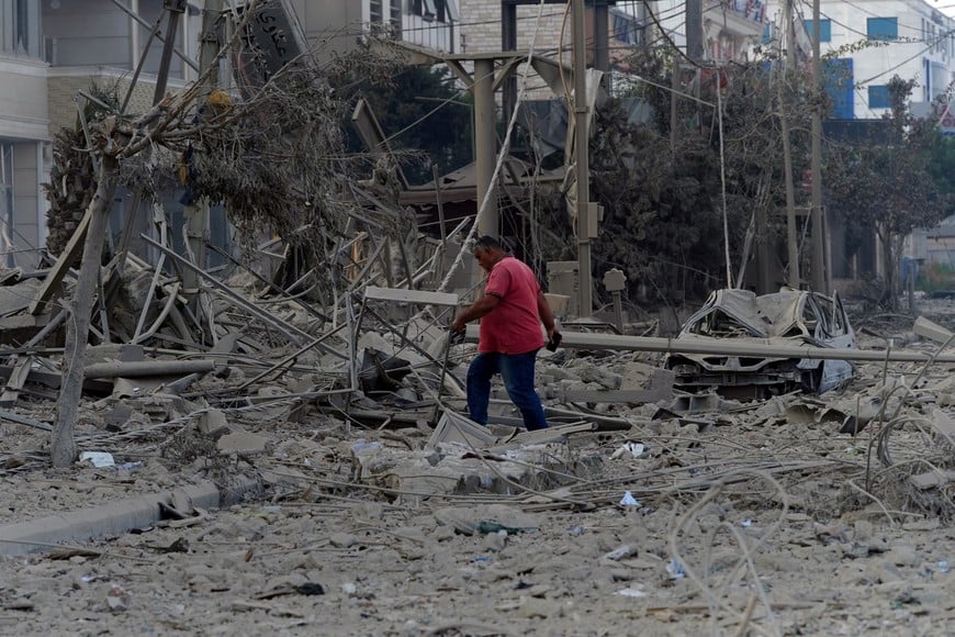 A man walks on the rubble of a damaged site, in the aftermath of Israeli strikes on Beirut's southern suburbs, amid the ongoing hostilities between Hezbollah and Israeli forces, Lebanon, October 6, 2024. REUTERS/Stringer