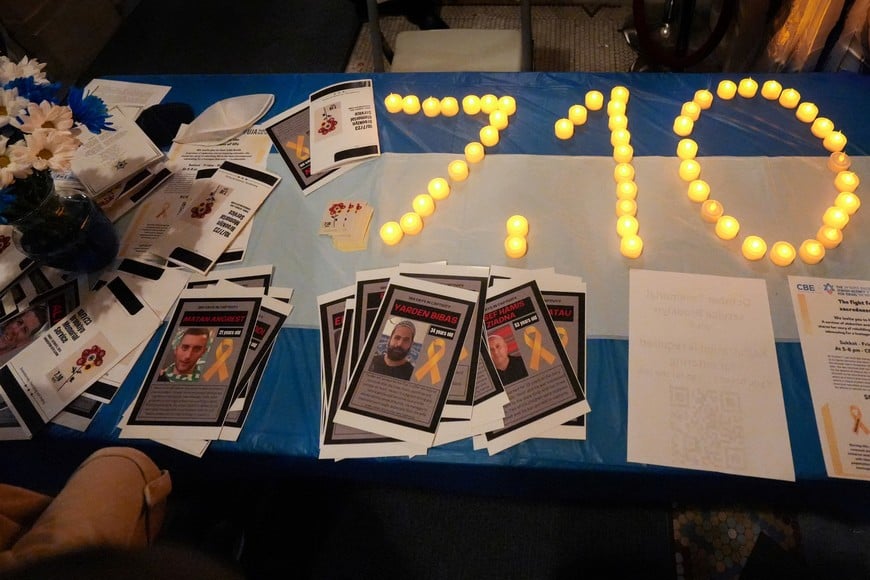 Flyers featuring pictures of hostages kidnapped during the October 7, 2023 attack on Israel by Hamas are placed on a table during a mourning prayer service at Congregation Beth Elohim nearly one year after the attack, in the Brooklyn borough of New York City, U.S. October 6, 2024.  REUTERS/Stephani Spindel