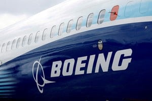 FILE PHOTO: The Boeing logo is seen on the side of a Boeing 737 MAX at the Farnborough International Airshow, in Farnborough, Britain, July 20, 2022.  REUTERS/Peter Cziborra/File Photo