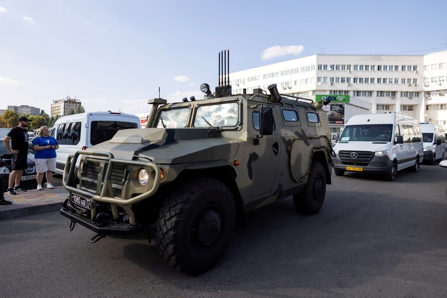 A Russian armoured vehicle drives in front of the buses carrying International Atomic Energy Agency (IAEA) Director General Rafael Grossi and IAEA officials following their visit to the Kursk Nuclear Power Plant (KNPP), in the town of Kurchatov, Russia August 27, 2024. REUTERS/Maxim Shemetov