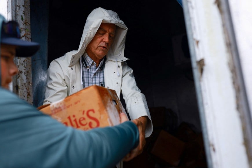 Jeff Schorner gathers food from his business, Al's Family Farms, which he lost following Hurricane Milton landfall, in Lakewood Park, near Fort Pierce, in St. Lucie County, Florida, U.S., October 11, 2024. REUTERS/Jose Luis Gonzalez