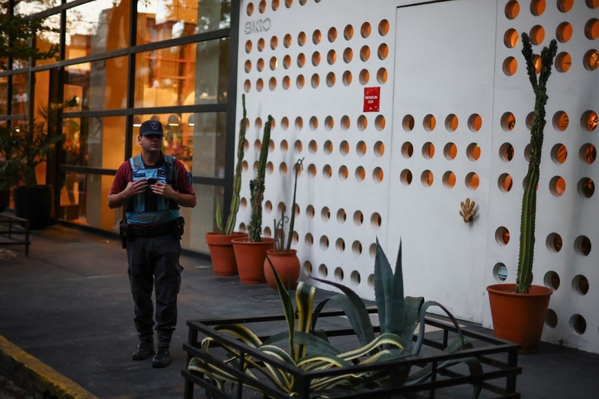 A police officer stands watch outside the hotel where Liam Payne, former One Direction member, was found dead, in Buenos Aires, Argentina, October 16, 2024. REUTERS/Agustin Marcarian