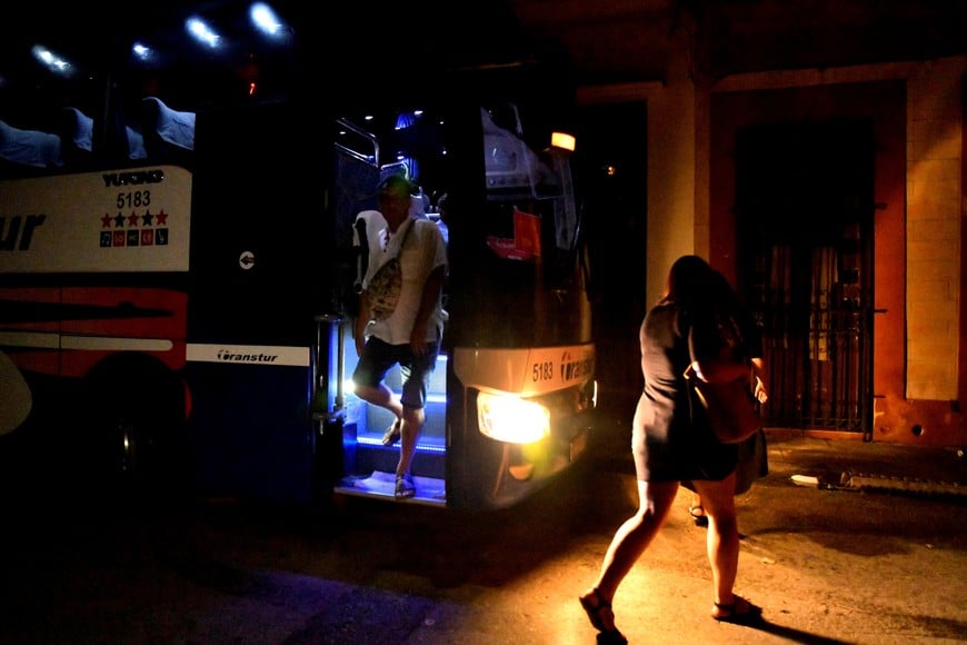 Tourists disembark from a bus at night as Cuba is hit by an island-wide blackout, in Havana, Cuba, October 18, 2024. REUTERS/Norlys Perez