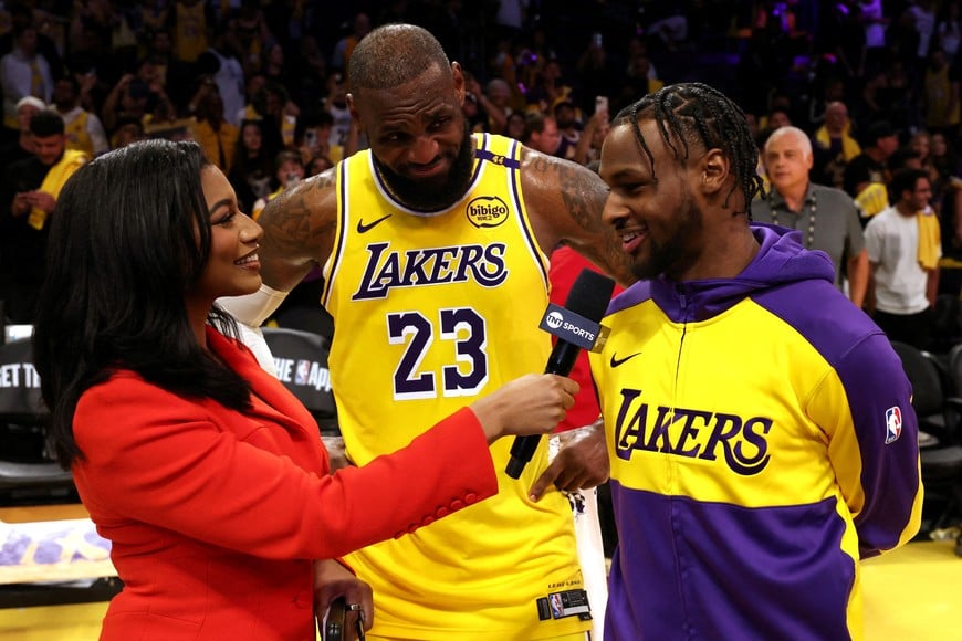 Oct 22, 2024; Los Angeles, California, USA; NBA on TNT sideline reporter Taylor Rooks interviews Los Angeles Lakers forward LeBron James (23) and guard Bronny James (9) after they defeated the Minnesota Timberwolves at Crypto.com Arena. Mandatory Credit: Jason Parkhurst-Imagn Images     TPX IMAGES OF THE DAY