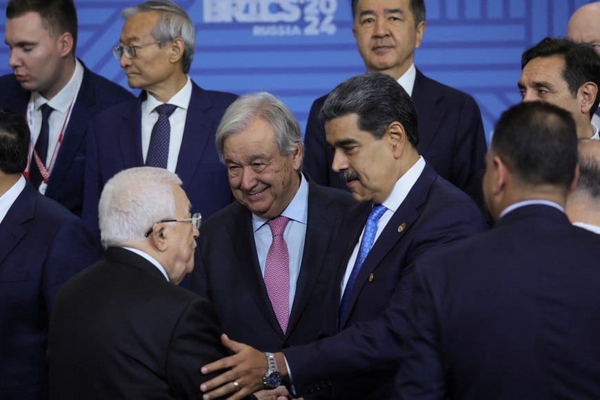 Palestinian President Mahmoud Abbas and United Nations Secretary-General Antonio Guterres, Venezuelan President Nicolas Maduro and other participants in the outreach/BRICS Plus format meeting pose for a family photo during the BRICS summit in Kazan, Russia, 24 October 2024. MAXIM SHIPENKOV/Pool via REUTERS