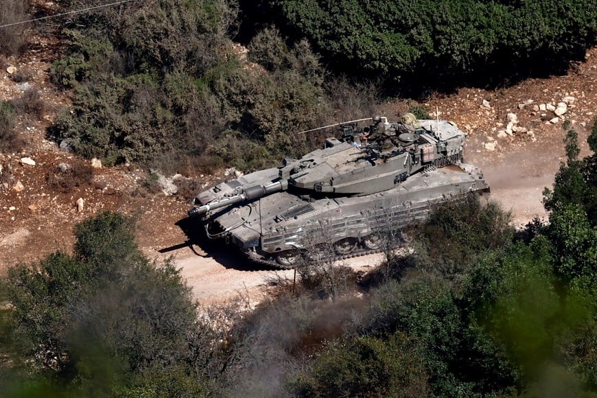 Israeli soldiers manoeuvre a tank near the border with Lebanon, amid ongoing hostilities between Hezbollah and Israeli forces, as seen from northern Israel, October 26, 2024. REUTERS/Gonzalo Fuentes