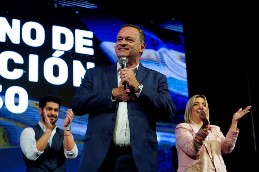 National Party presidential candidate Alvaro Delgado addresses supporters with his running mate Valeria Ripoll and Colorado Party presidential candidate Andres Ojeda following the first exit polls during the general election, in Montevideo, Uruguay October 27, 2024. REUTERS/Andres Cuenca     TPX IMAGES OF THE DAY