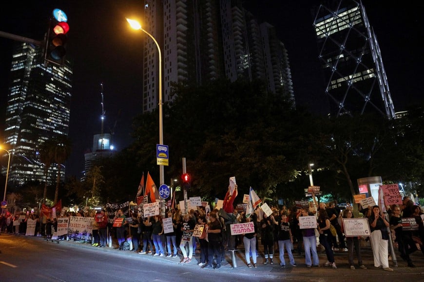 Israeli left-wing activists hold signs and banners during a protest against Israel's actions in the Gaza Strip, amid the ongoing Israel-Hamas conflict, in Tel Aviv, Israel, October 27, 2024. REUTERS/Violeta Santos Moura