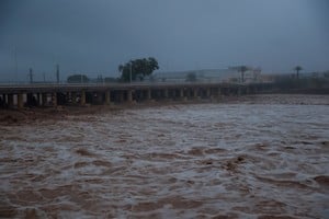 River water churns, with a partially collapsed bridge seen in the background, after torrential rains caused flooding in the town of Carlet, Valencia region, Spain, October 30, 2024. REUTERS/Eva Manez