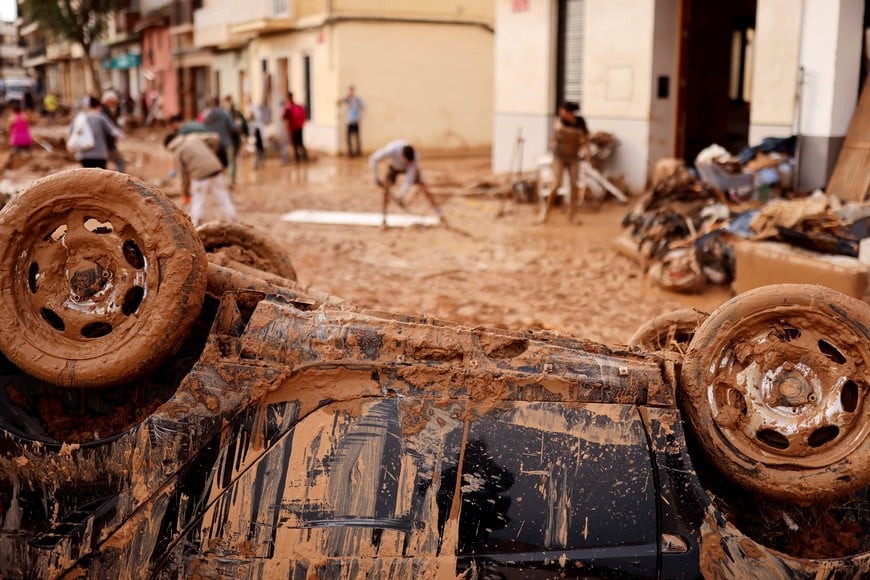 A damaged vehicle is pictured as volunteers and locals help to clean up places affected by heavy rains that caused floods, in Paiporta, near Valencia, Spain, November 1, 2024. REUTERS/Nacho Doce