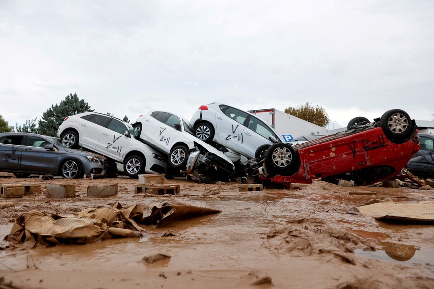 A view shows vehicles marked by firefighters, with a code indicating that they have searched for casualties, following heavy rains that caused floods, in Paiporta, near Valencia, Spain, November 3, 2024. REUTERS/Eva Manez     TPX IMAGES OF THE DAY