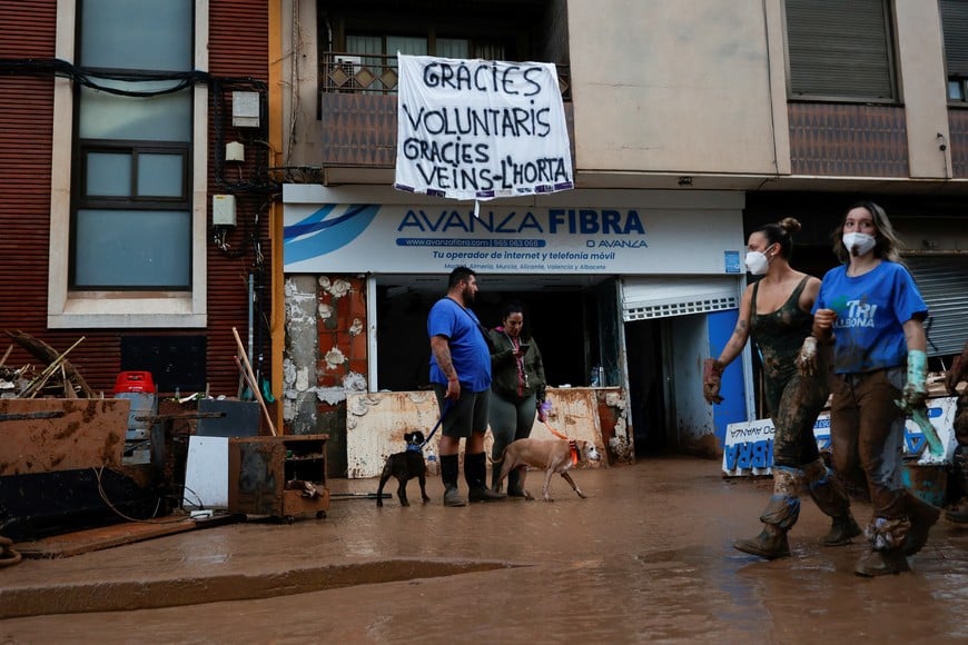 A sign reading "Thank you volunteers, thank you neighbours" hangs from a balcony following heavy rains that caused floods, in Paiporta, near Valencia, Spain, November 4, 2024. REUTERS/Eva Manez