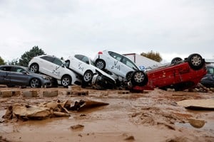 A view shows vehicles marked by firefighters, with a code indicating that they have searched for casualties, following heavy rains that caused floods, in Paiporta, near Valencia, Spain, November 3, 2024. REUTERS/Eva Manez