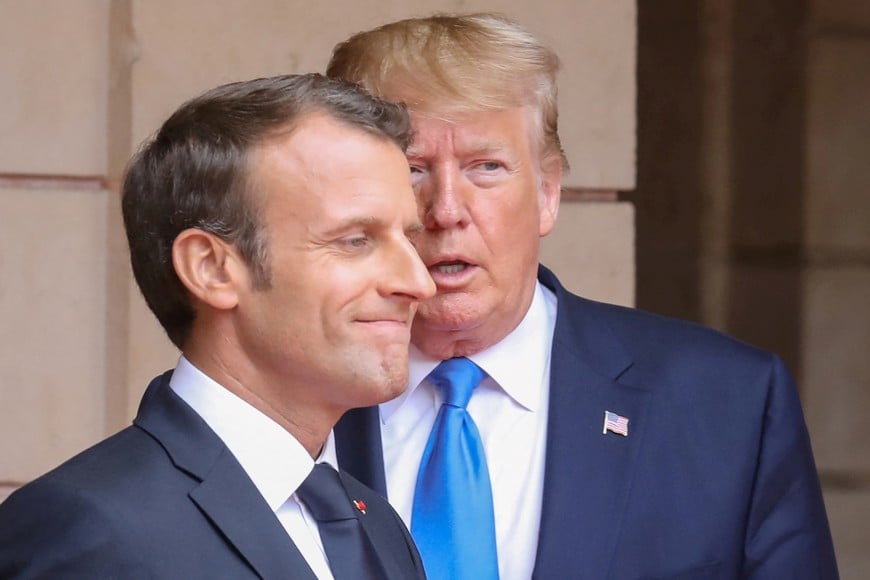 FILE PHOTO: French President Emmanuel Macron speaks with U.S. President Donald Trump ahead of a meeting at the Prefecture of Caen, on the sidelines of D-Day commemorations marking the 75th anniversary of the World War II Allied landings in Normandy, France,  June 6, 2019. Ludovic Marin/Pool via REUTERS/File Photo