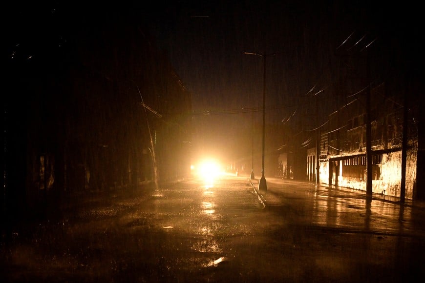 Lights from a car illuminate a street as the energy grid suffers a complete blackout while Hurricane Rafael makes landfall in Artemisa province as a category three hurricane, in Havana, Cuba November 6, 2024. REUTERS/Norlys Perez