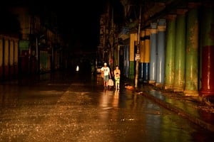 People walk on the street as the energy grid suffers a complete blackout while Hurricane Rafael makes landfall in Artemisa province as a category three hurricane, in Havana, Cuba November 6, 2024. REUTERS/Norlys Perez