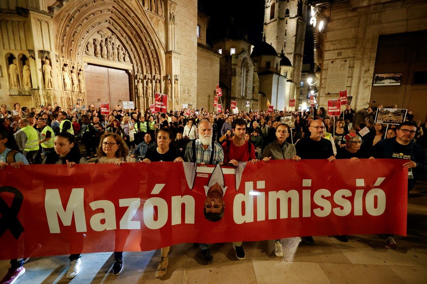 People hold a banner calling for the resignation of Valencia's regional leader Carlos Mazon, as civil groups and unions protest against the management of the emergency response to the deadly floods in eastern Spain, in Valencia, Spain, November 9, 2024. REUTERS/Eva Manez