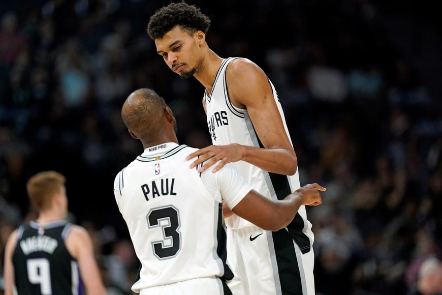 Nov 11, 2024; San Antonio, Texas, USA; San Antonio Spurs guard Chris Paul (3) talks with center Victor Wembanyama (1) during the second half against the Sacramento Kings at Frost Bank Center. Mandatory Credit: Scott Wachter-Imagn Images