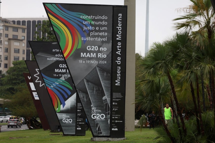 A person walks next to G20 summit banners, outside the Museum of Modern Art (MAM), venue of the G20 summit, in Rio de Janeiro, Brazil November 13, 2024. REUTERS/Pilar Olivares