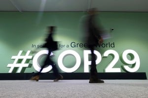 People walk past a COP29 logo during the United Nations Climate Change Conference (COP29), in Baku, Azerbaijan November 14, 2024. REUTERS/Murad Sezer REFILE - QUALITY REPEAT