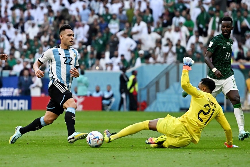 Soccer Football - FIFA World Cup Qatar 2022 - Group C - Argentina v Saudi Arabia - Lusail Stadium, Lusail, Qatar - November 22, 2022 
Argentina's Lautaro Martinez is tackled by Saudi Arabia's Mohammed Al-Owais REUTERS/Dylan Martinez