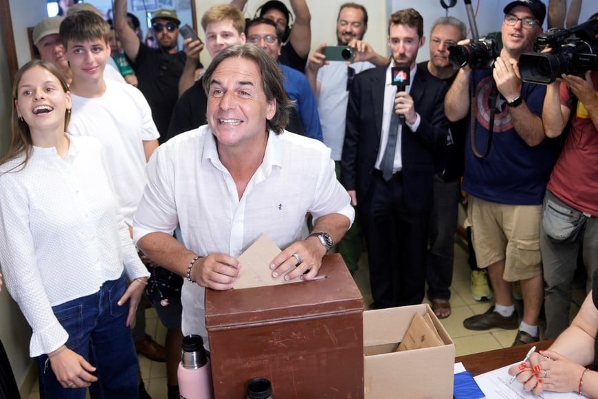 (241124) -- CANELONES, 24 noviembre, 2024 (Xinhua) -- El presidente uruguayo, Luis Lacalle Pou (2-i), reacciona junto a sus hijos al emitir su voto durante la segunda vuelta de las elecciones presidenciales en su circuito de votación, en Canelones, Uruguay, el 24 de noviembre de 2024. Lacalle Pou votó el domingo en la segunda vuelta de las elecciones presidenciales y dijo que esta misma noche llamará a quien resulte el candidato ganador entre el oficialista Alvaro Delgado y el opositor Yamandú Orsi para que se abra el proceso de transición de mandato. (Xinhua/Nicolás Celaya) (nc) (rtg) (ah)