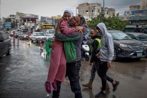 Mohammed Sleem hugs his daughter Menisa Sleem, as he meets her after two months, according to Mohammed, after a ceasefire between Israel and Iran-backed group Hezbollah took effect at 0200 GMT on Wednesday after U.S. President Joe Biden said both sides accepted an agreement brokered by the United States and France, in Tyre, Lebanon, November 27, 2024. REUTERS/Adnan Abidi REFILE - CORRECTING FROM "HUGS HER DAUGHTER" TO "HUGS HIS DAUGHTER".     TPX IMAGES OF THE DAY