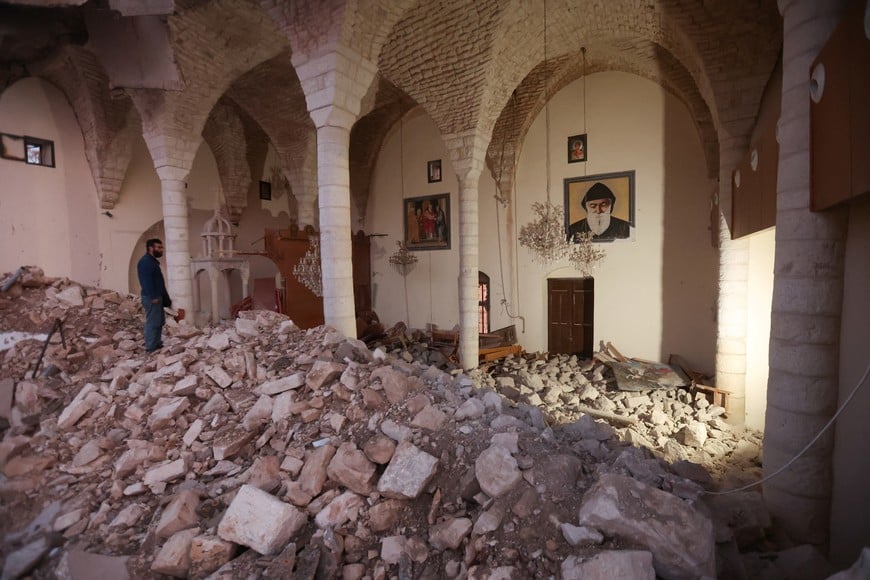 A man stands on the rubble inside a damaged church in Derdghaiya, on the second day of the ceasefire between Israel and Iran-backed group Hezbollah, southern Lebanon November 28, 2024. REUTERS/Aziz Taher