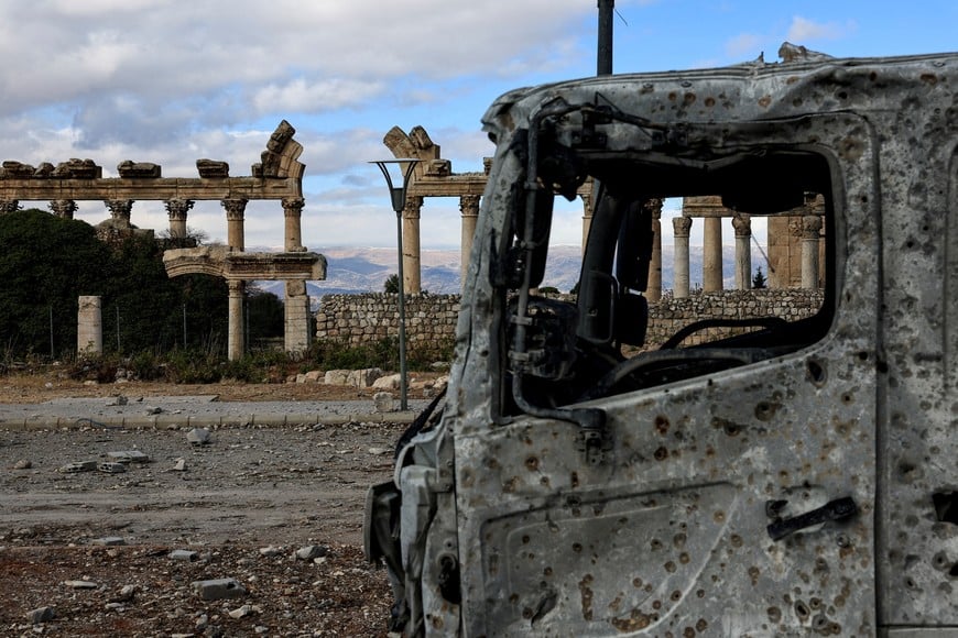 A damaged vehicle sits near the Roman ruins, on the second day of the ceasefire between Israel and Hezbollah, in the eastern city of Baalbek, Lebanon November 28, 2024. REUTERS/Thaier Al-Sudani     TPX IMAGES OF THE DAY