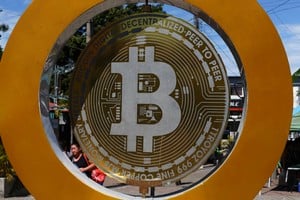 A woman passes by the Bitcoin Monument after bitcoin soared above $100,000, in Ilopango, El Salvador, December 5, 2024. REUTERS/Jose Cabezas