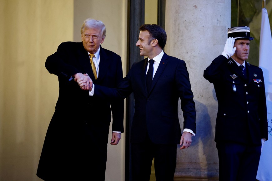 French President Emmanuel Macron shakes hands with U.S. President-elect Donald Trump as he arrives for a meeting at the Elysee Palace in Paris as part of ceremonies to mark the reopening of the Notre-Dame de Paris Cathedral, five-and-a-half years after a fire ravaged the Gothic masterpiece, in Paris, France, December 7, 2024. REUTERS/Sarah Meyssonnier