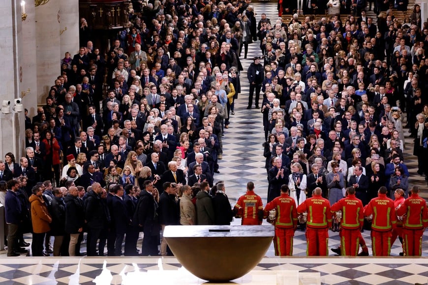 Guests applaud firefighters, rescuers and builders involved in the restoration of Notre-Dame Cathedral during a ceremony to mark the re-opening of landmark cathedral, following the 2019 fire, in Paris, France, December 7, 2024. LUDOVIC MARIN/Pool via REUTERS