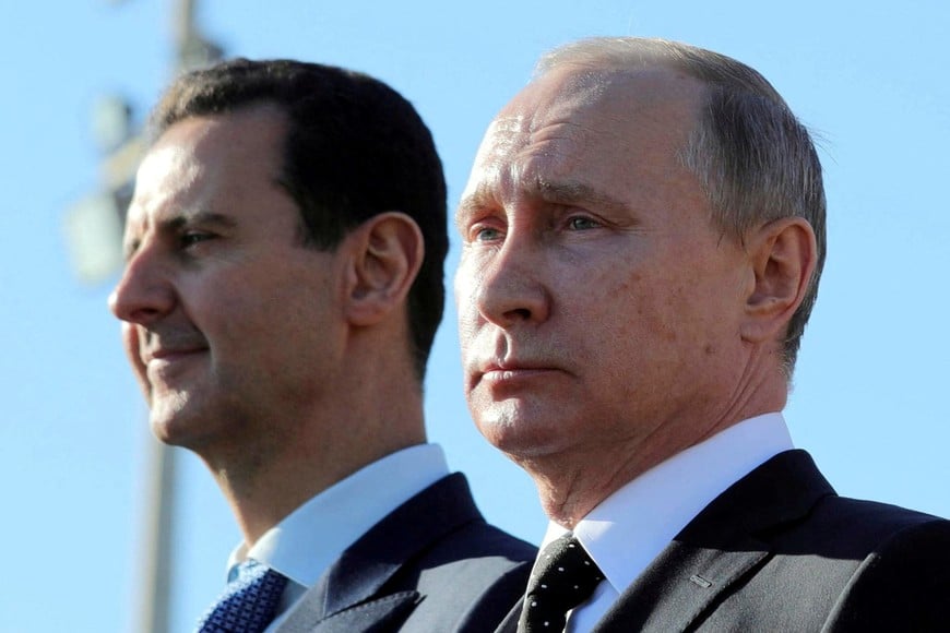 FILE PHOTO: Russian President Vladimir Putin (R) and Syrian President Bashar al-Assad visit the Hmeymim air base in Latakia Province, Syria December 11, 2017. Picture taken December 11, 2017. To match Special Report RUSSIA-FLIGHTS/ Sputnik/Mikhail Klimentyev/ via REUTERS/File Photo  ATTENTION EDITORS - THIS IMAGE WAS PROVIDED BY A THIRD PARTY./File Photo