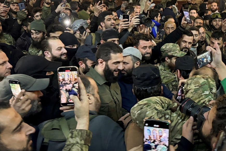 Top rebel commander Abu Mohammed al-Golani greets the crowd at Ummayad Mosque in Damascus, after Syrian rebels announced that they have ousted President Bashar al-Assad, Syria December 8, 2024. REUTERS/Mahmoud Hassano