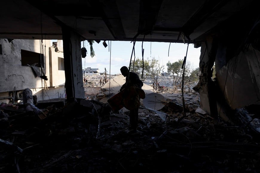 A Palestinian inspects the damage at the site of an Israeli strike, amid the Israel-Hamas conflict, at the Nuseirat refugee camp in the central Gaza Strip, December 13, 2024. REUTERS/Ramadan Abed