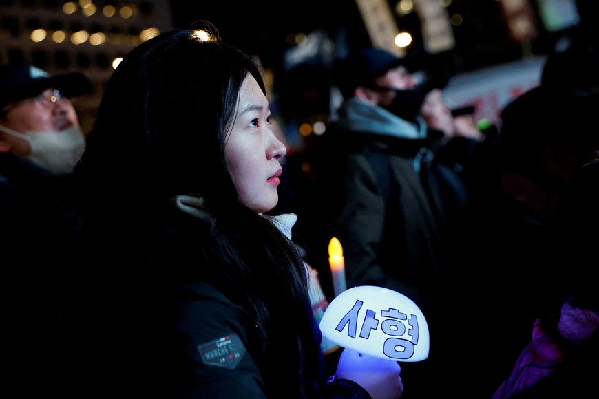 People listen to Lee Jae-myung, leader of the main opposition Democratic Party speak during a rally calling for the impeachment of President Yoon Suk Yeol, who declared martial law, which was reversed hours later, in front of the National Assembly in Seoul, South Korea, December 14, 2024. REUTERS/Kim Soo-hyeon