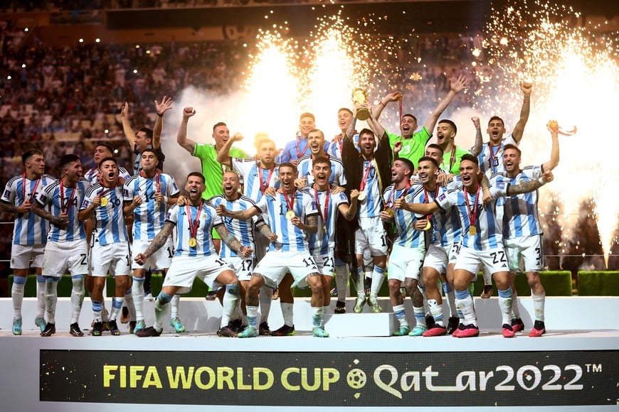 FILE PHOTO: Soccer Football - FIFA World Cup Qatar 2022 - Final - Argentina v France - Lusail Stadium, Lusail, Qatar - December 18, 2022
Argentina's Lionel Messi celebrates with the trophy and teammates after winning the World Cup REUTERS/Carl Recine/File Photo