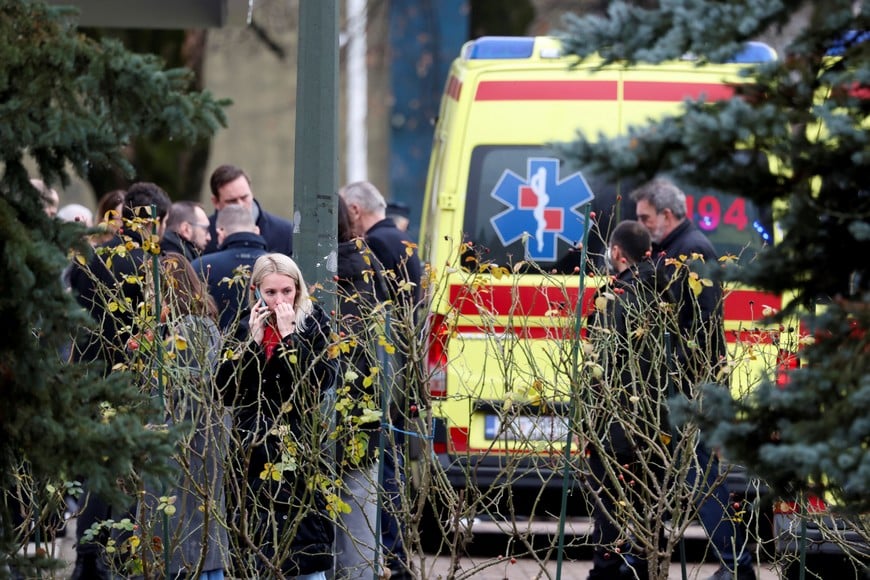 People stand near an ambulance, following a knife attack in a primary school, in Zagreb, Croatia, December 20, 2024. REUTERS/Antonio Bronic     TPX IMAGES OF THE DAY