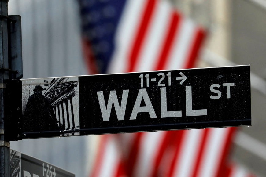 FILE PHOTO: A sign for Wall Street outside the New York Stock Exchange in Manhattan in New York City, New York, U.S., October 26, 2020. REUTERS/Mike Segar/File Photo