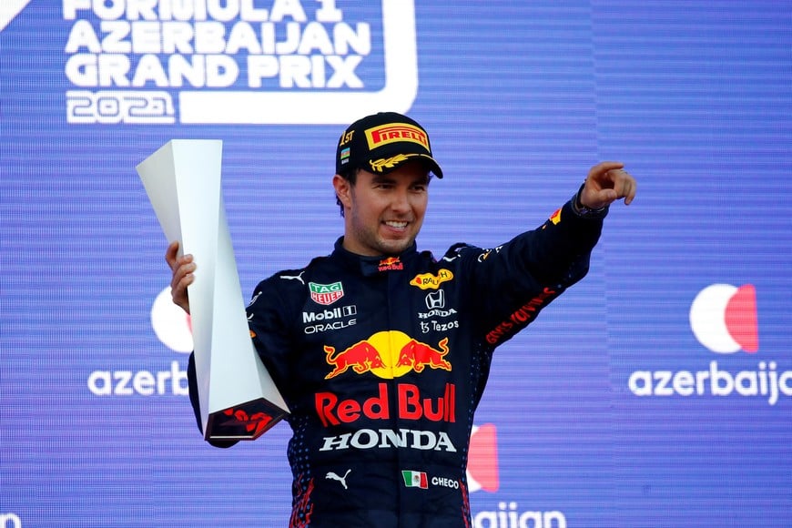 FILE PHOTO: Formula One F1 - Azerbaijan Grand Prix - Baku City Circuit, Baku, Azerbaijan - June 6, 2021 Red Bull's Sergio Perez celebrates with a trophy on the podium after winning the race Pool via REUTERS/Maxim Shemetov/File photo
NO RESALES. NO ARCHIVES