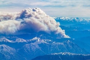 A column of smoke rises from a wildfire near Matin Lake near Bariloche, at the Patagonia region, in Argentina, December 26, 2024. REUTERS/Carlos Barria