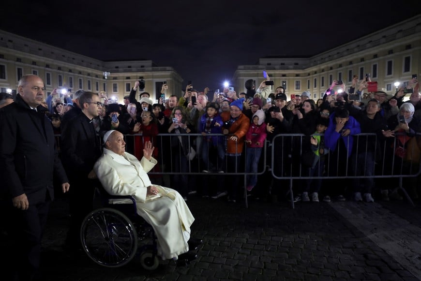 Pope Francis gestures at people as he passes by, at the Vatican, December 31, 2024. REUTERS/Claudia Greco