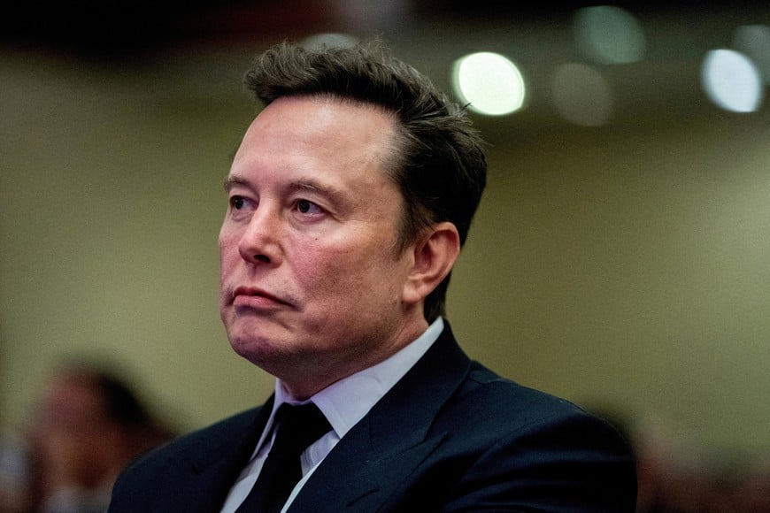 FILE PHOTO: Tesla CEO and X owner Elon Musk listens as US President-elect Donald Trump speaks during a meeting with House Republicans at the Hyatt Regency hotel in Washington, DC, U.S. on November 13, 2024.  ALLISON ROBBERT/Pool via REUTERS/File Photo